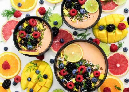 A colorful assortment of fresh fruit bowls featuring mixed berries and citrus slices, perfect for healthy eating inspiration.